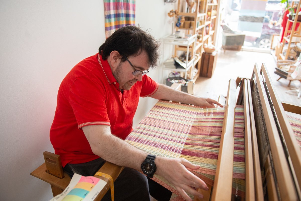 Master weaver Tommy Moore creating his famous waffle weave fabric on a floor loom at Entwine.