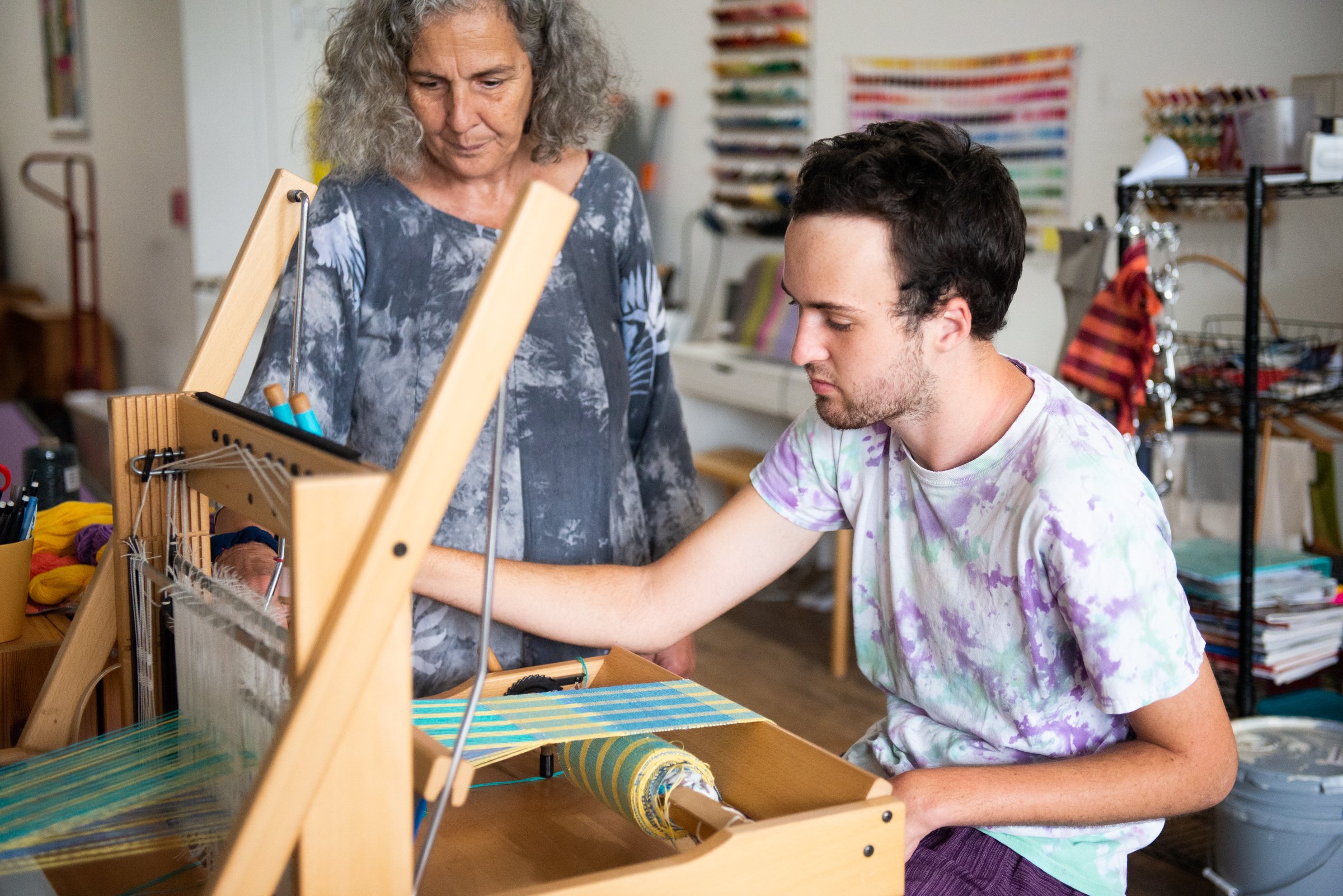 Tevaki V. and mother, Mar, weaving on a table loom at Entwine. 