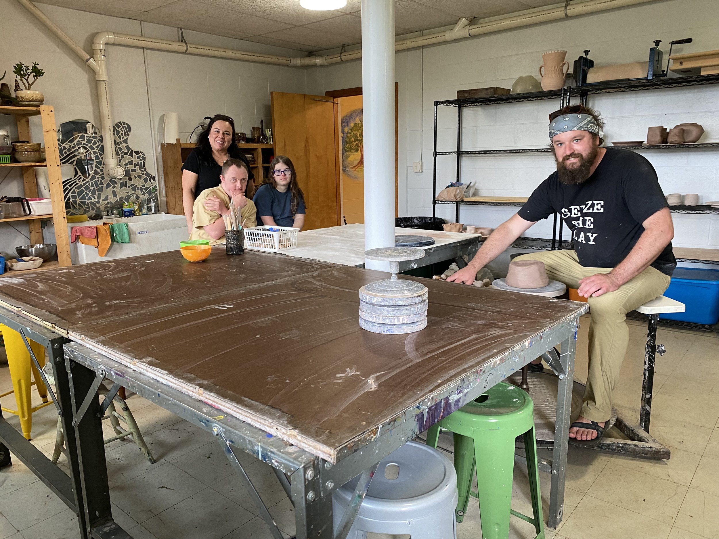 Soltane Pottery instructor, Ryan Hagen, and students in the Soltane Pottery
