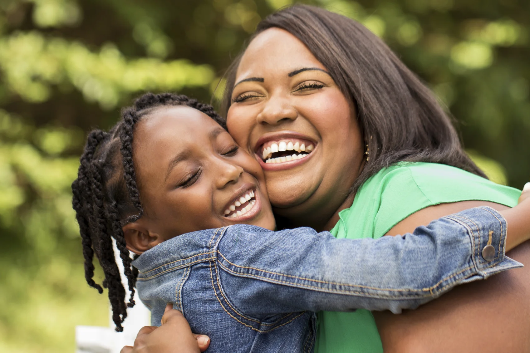 A smiling woman and young child embrace