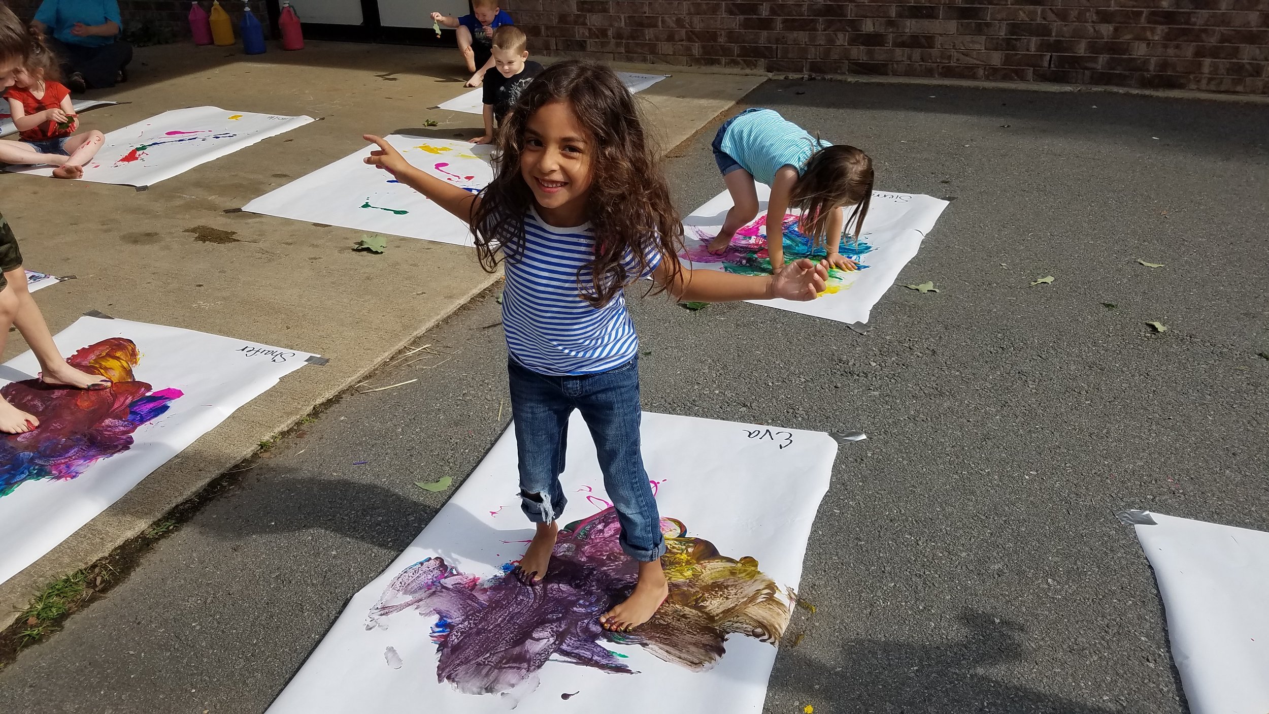 Cabot East Justice Childcare having fun messy paint sunny day 6.jpg
