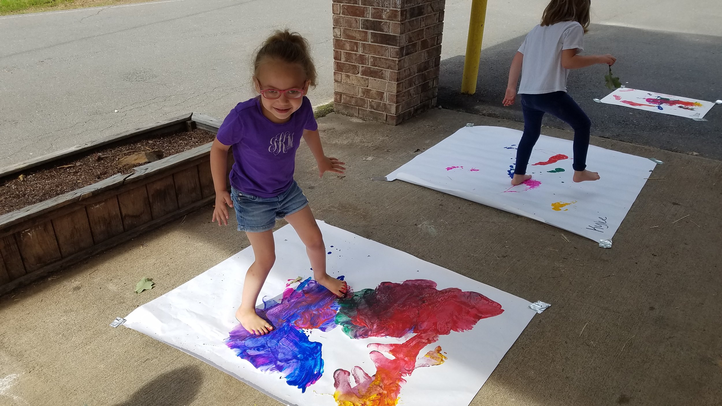 Cabot East Justice Childcare having fun messy paint sunny day 4.jpg