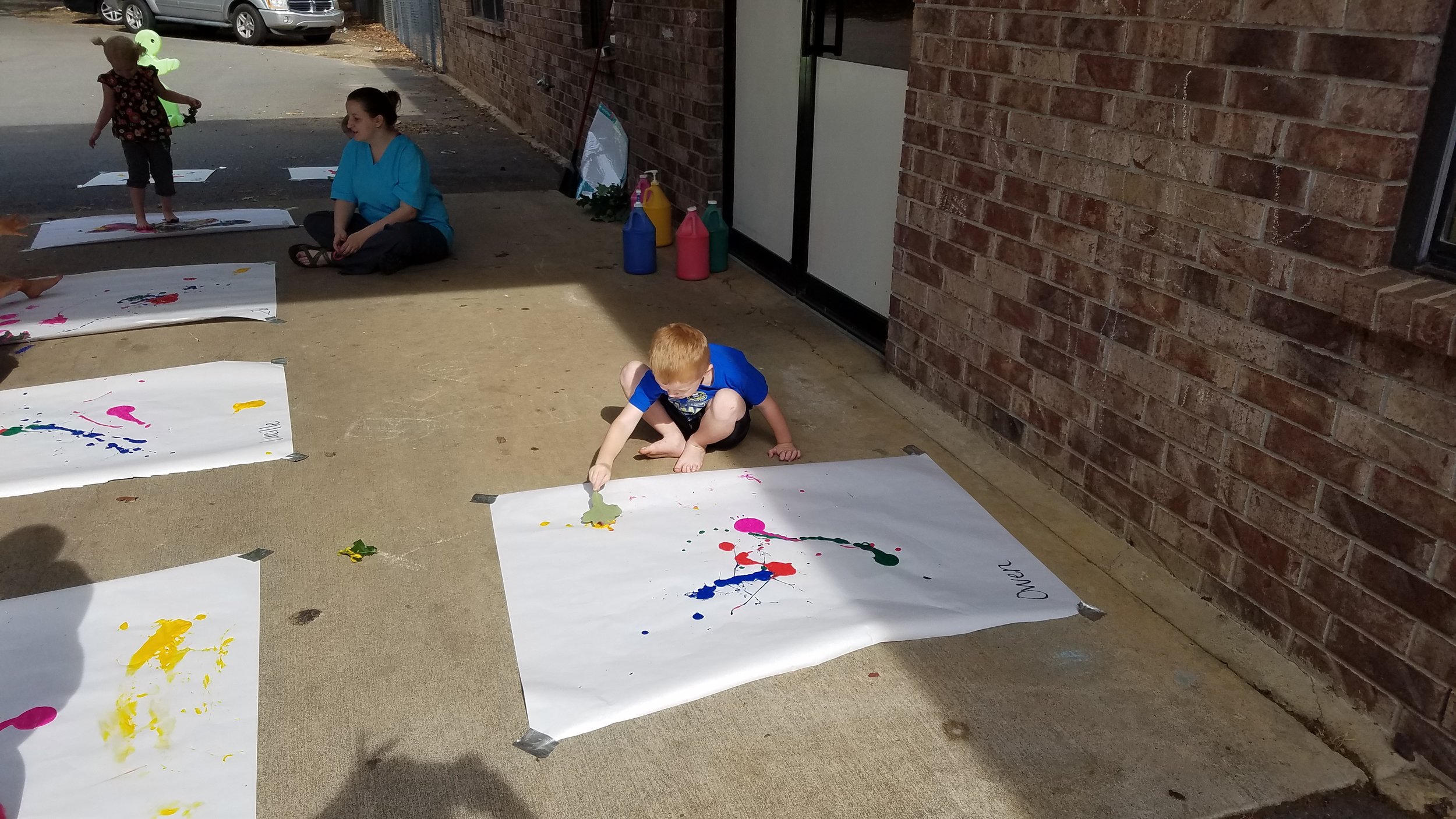 Cabot East Justice Childcare having fun messy paint sunny day 5.jpg