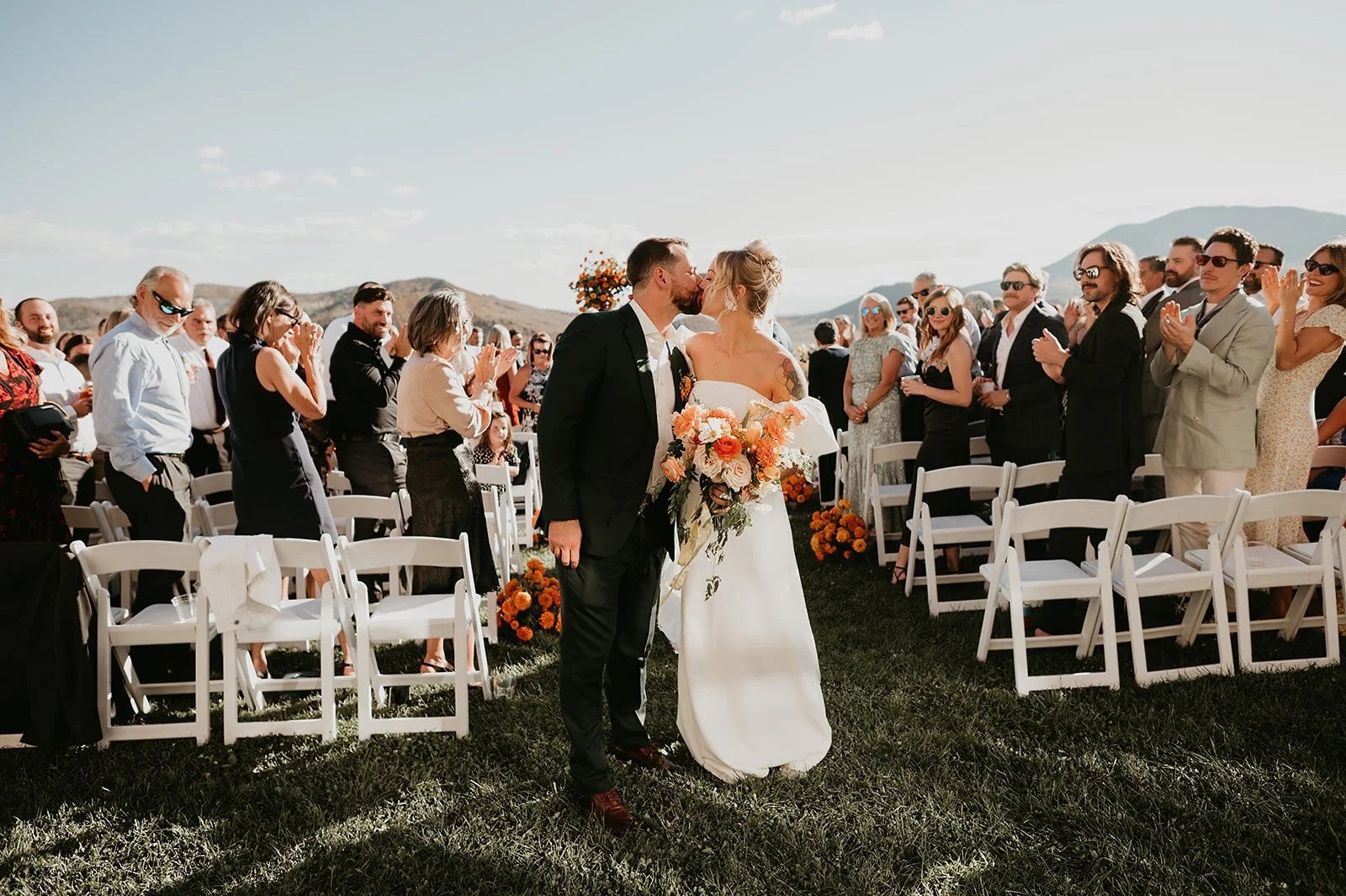 Newlyweds kiss in the aisle of La Joya Dulce wedding ceremony