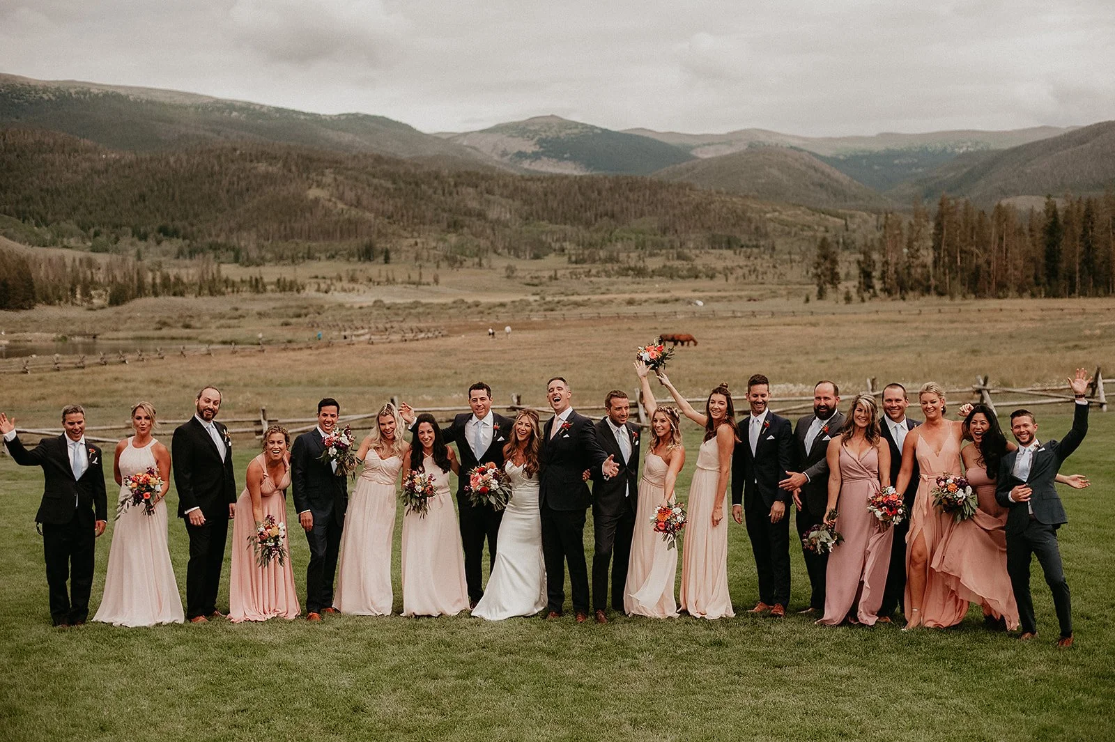 Devil's Thumb Ranch wedding party posing in front of mountains