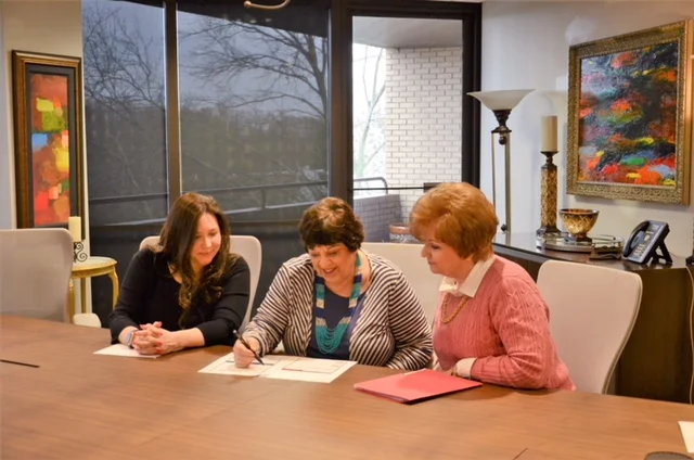Sherry Linda and Susan looking at paper.jpg
