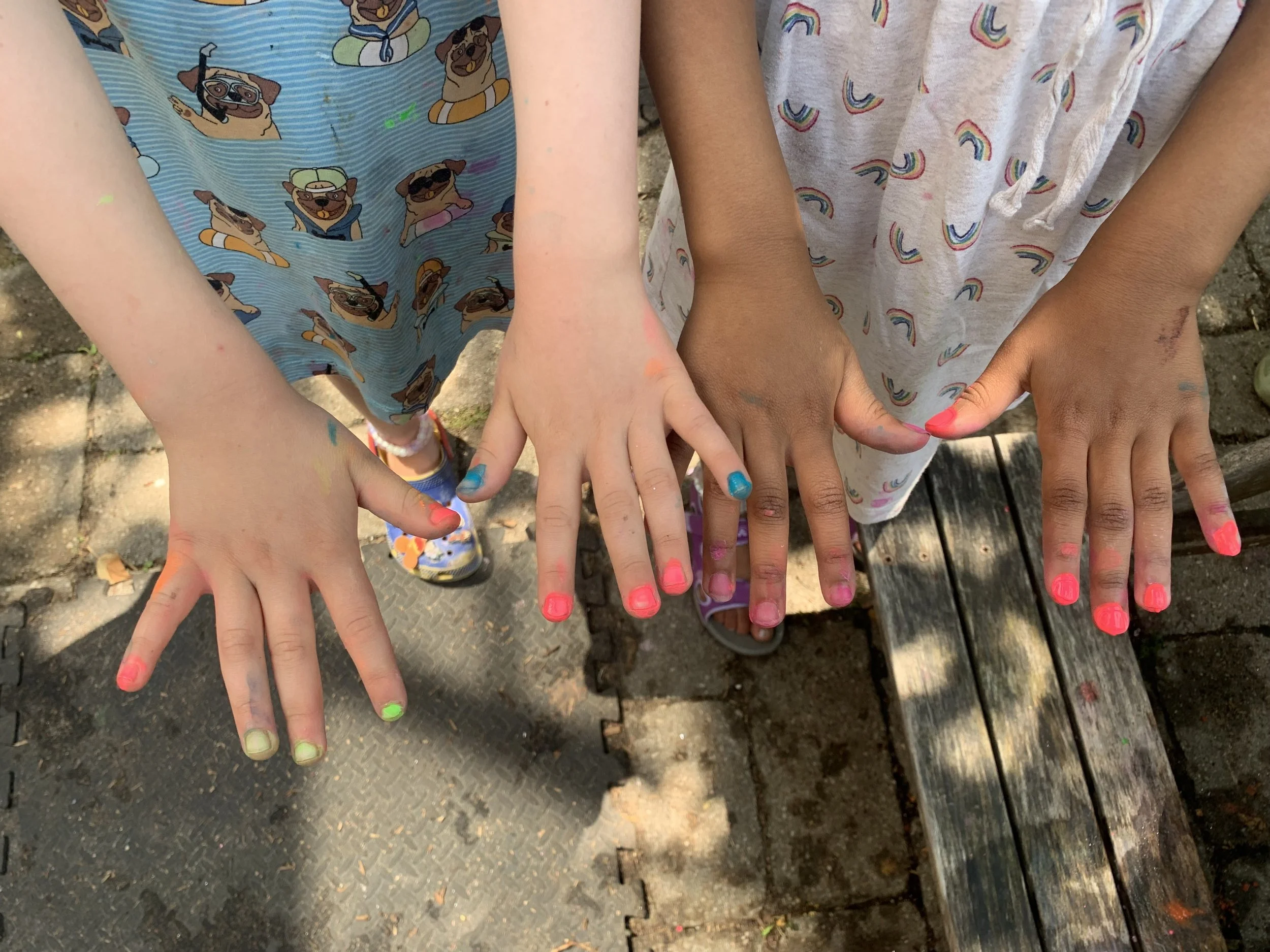children's hands with colourful painted nails