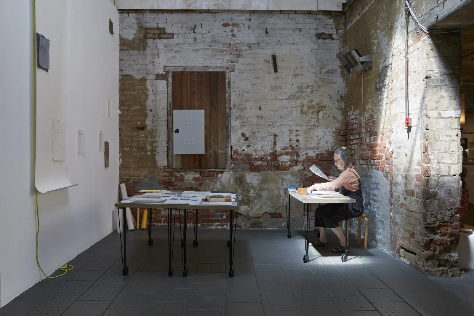  SARAH RUDLEDGE  I’ve been trying to reach you… , 2026graphite on various papers, studio table, writing materials, performance 