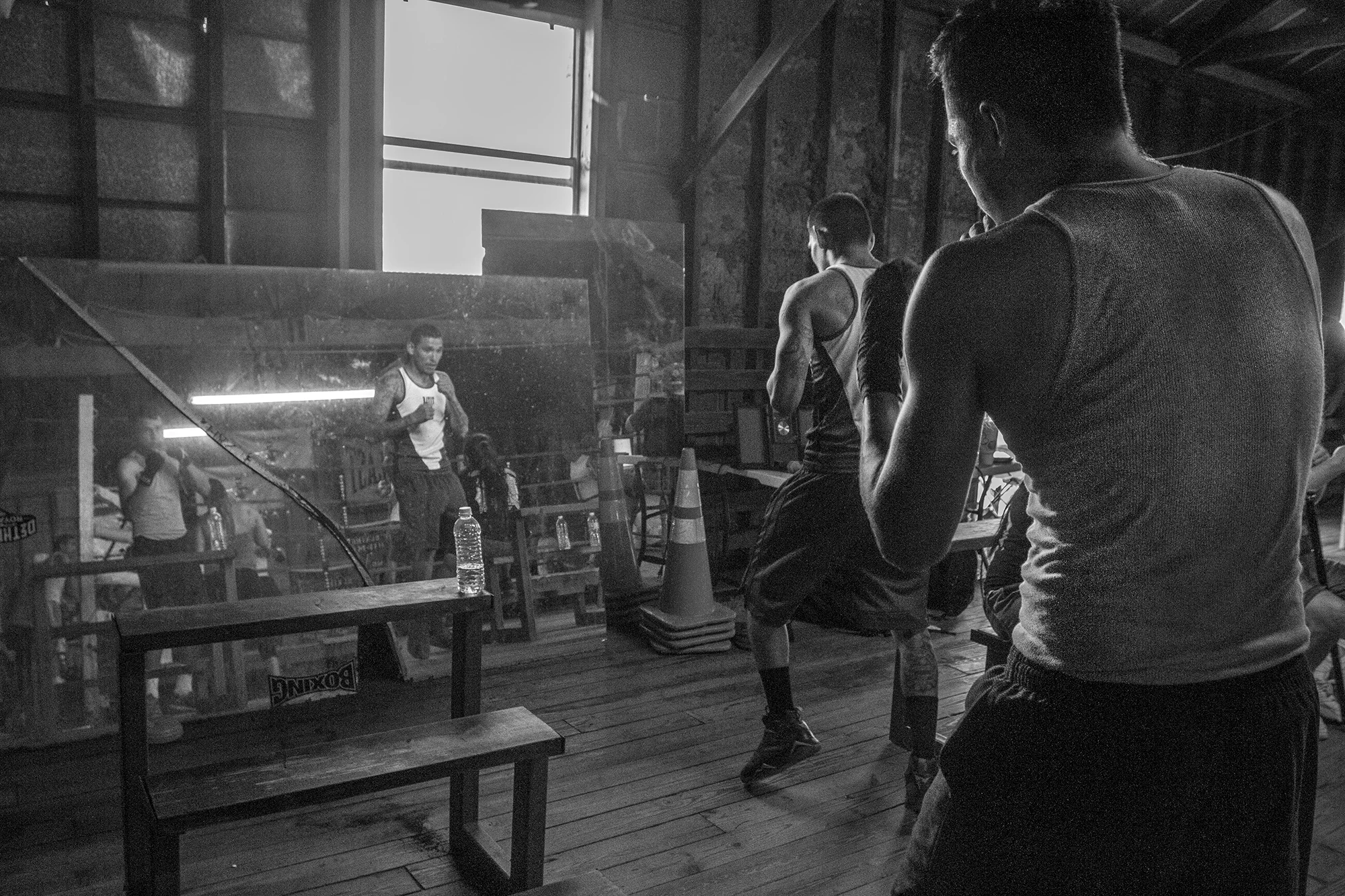 Albert Perez (right) and David Lopez practice their punches in the mirror before heading into the boxing ring.