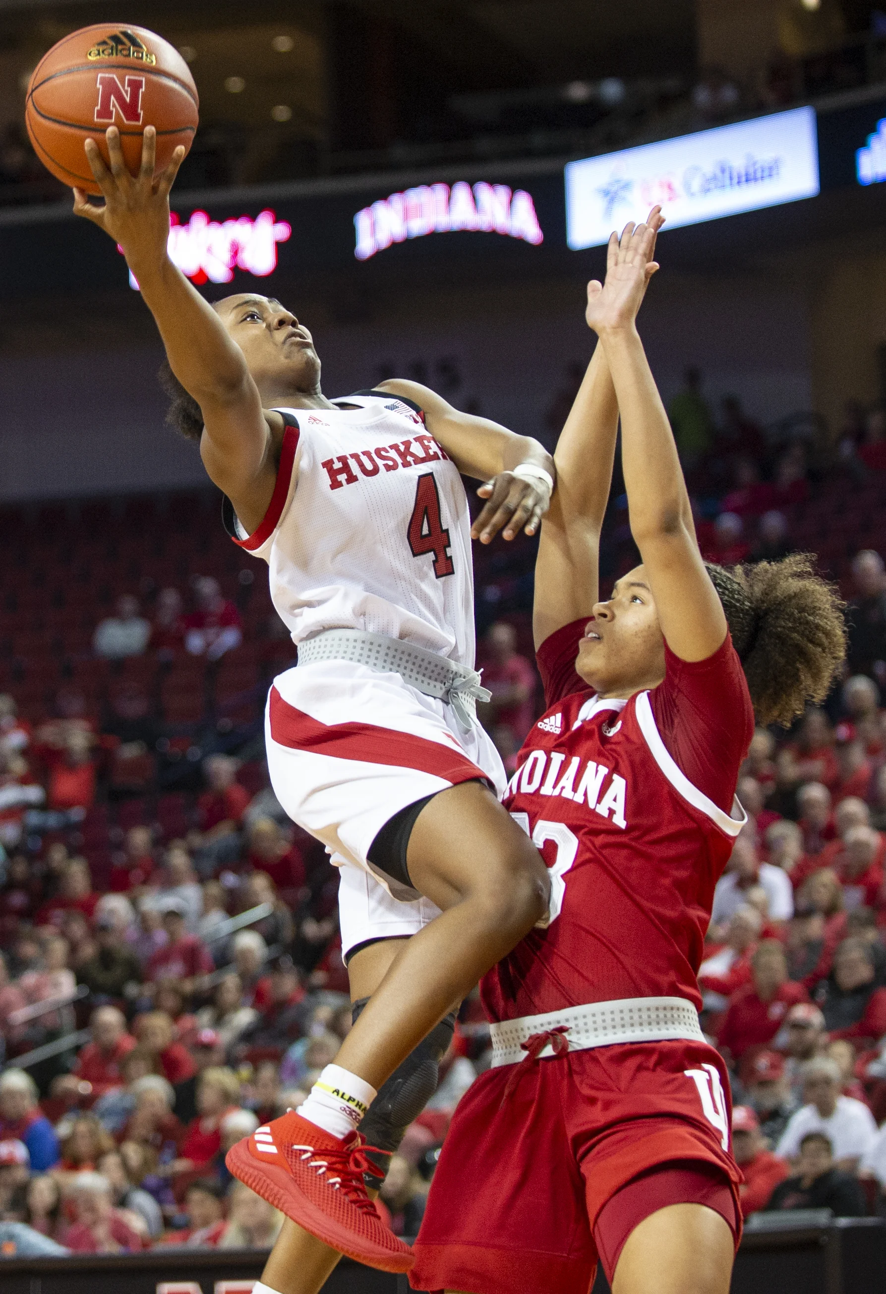 Lincoln, NE - Indiana guard Jaelynn Penn (13) tries to block Nebraska guard Sam Haiby (4) as she goes to do a layup on Sunday, Feb. 3, 2019, at Pinnacle Bank Arena.