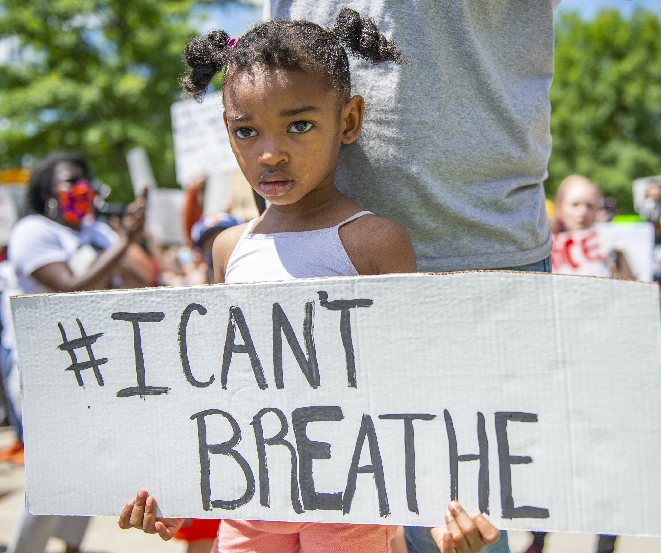 3-year-old Elizabeth Payton holds up during the George Floyd protest in downtown Greenville.