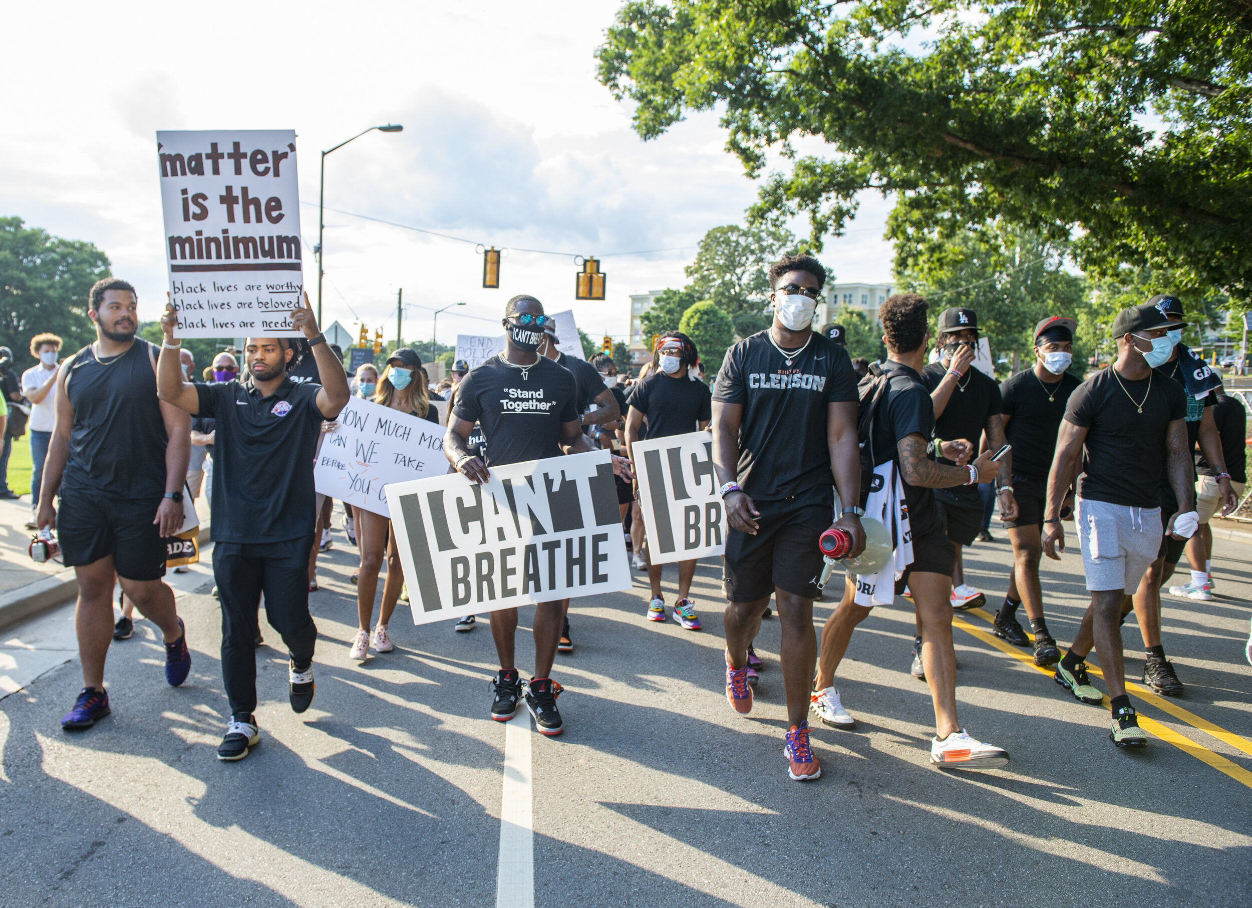 Clemson football players lead thousands of peaceful protesters around the Clemson University campus.
