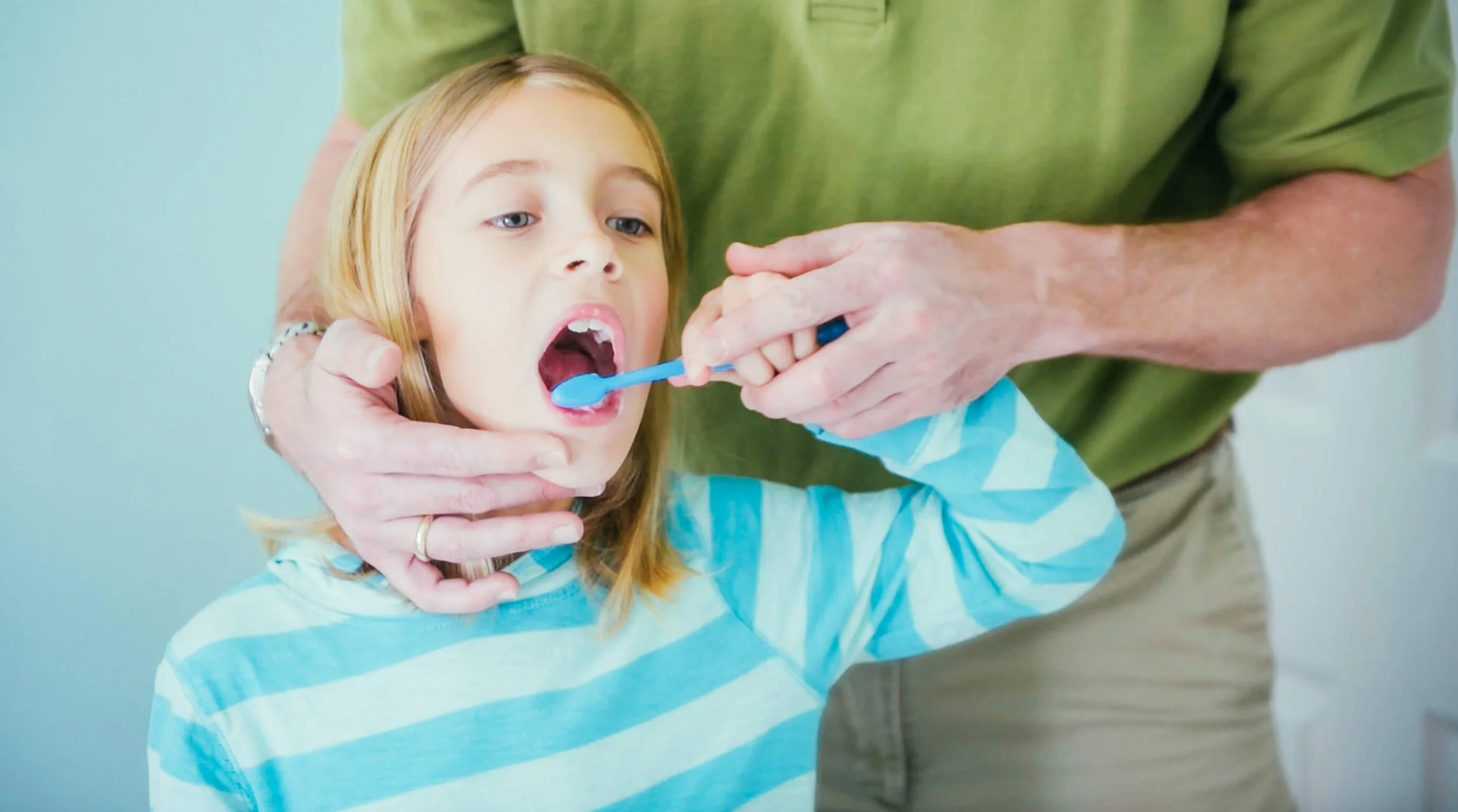 For kids, until what age do parents need to help directly with toothbrushing?