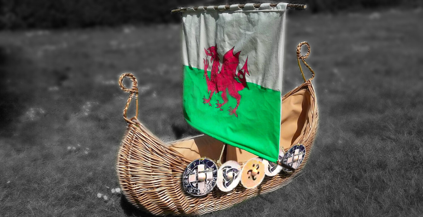 viking ship casket with wooden shields.jpg