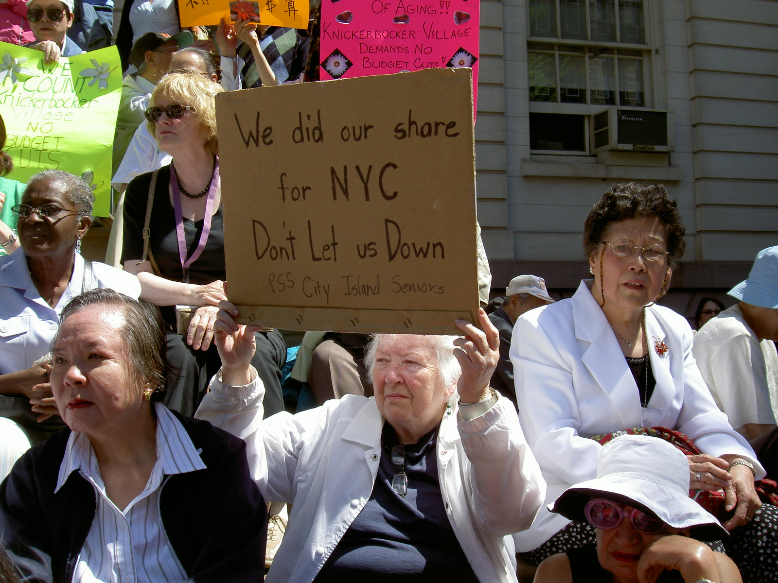 Senior Holds Homemade Sign at Rally