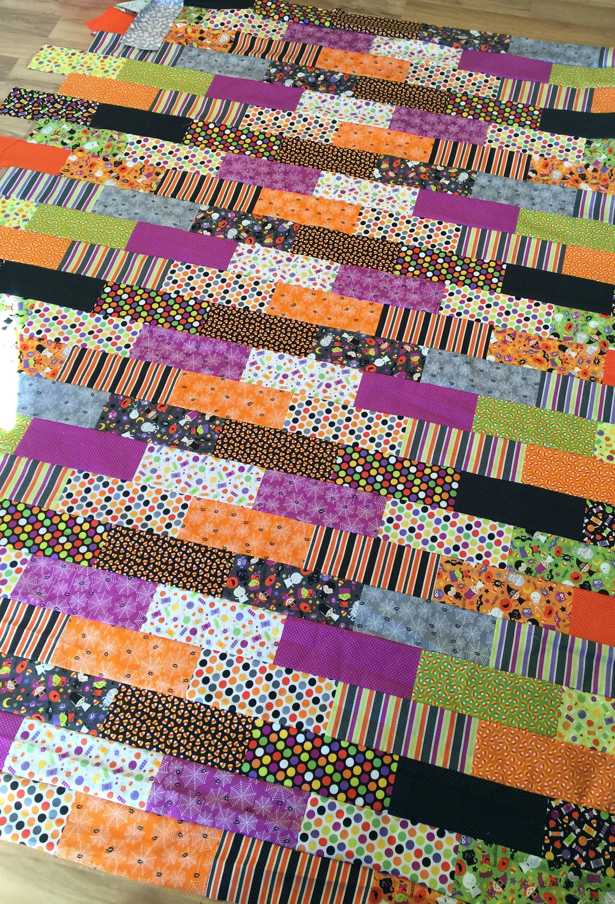 Halloween Brick Quilt | I designed this quilt to use an entire fat quarter bundle with minimal waste, the brick shaped rectangles are arranged so that I didn't have to match up any seams when piecing this patchwork quilt.