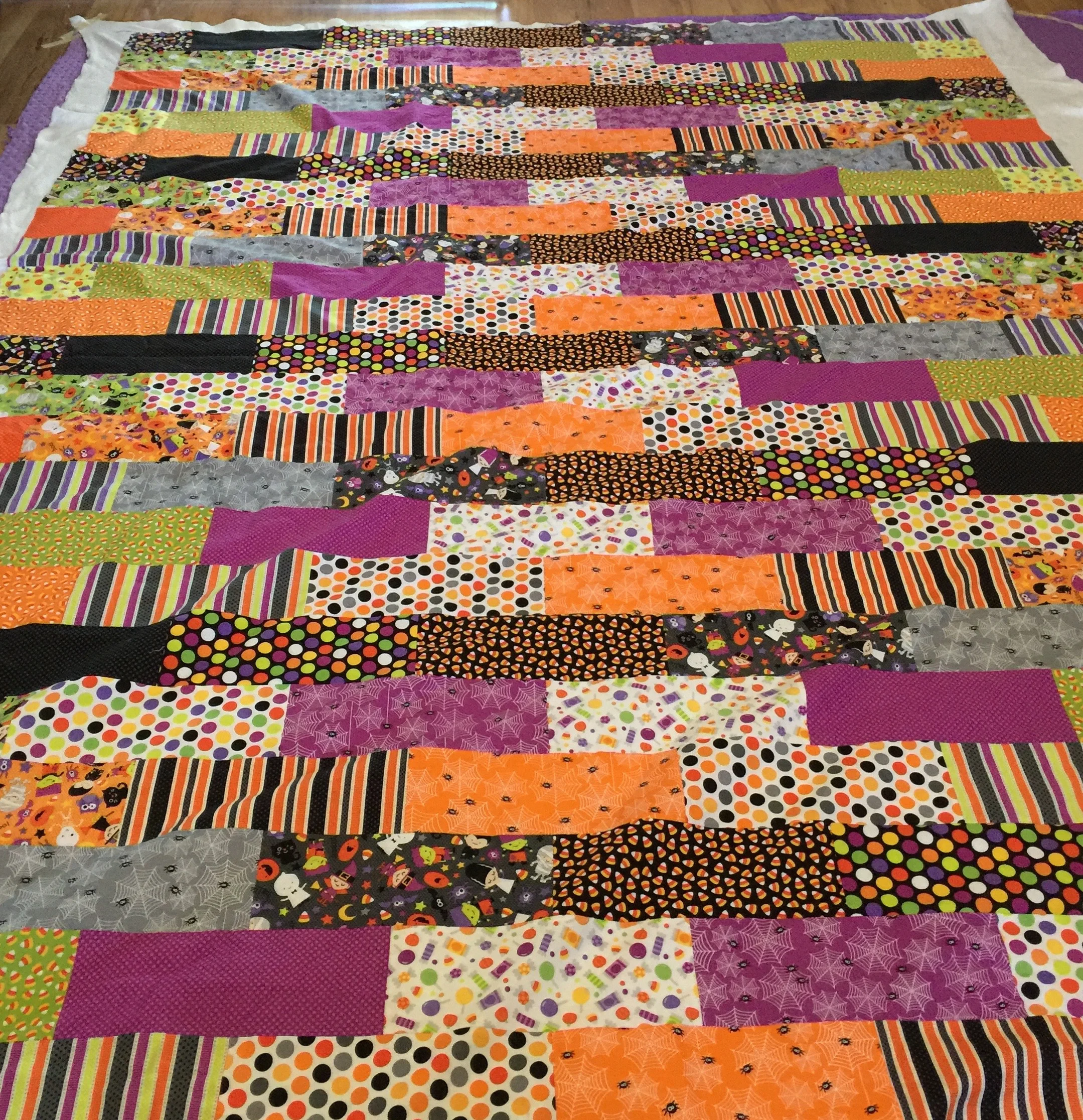 Halloween Brick Quilt | I designed this quilt to use an entire fat quarter bundle with minimal waste, the brick shaped rectangles are arranged so that I didn't have to match up any seams when piecing this patchwork quilt.