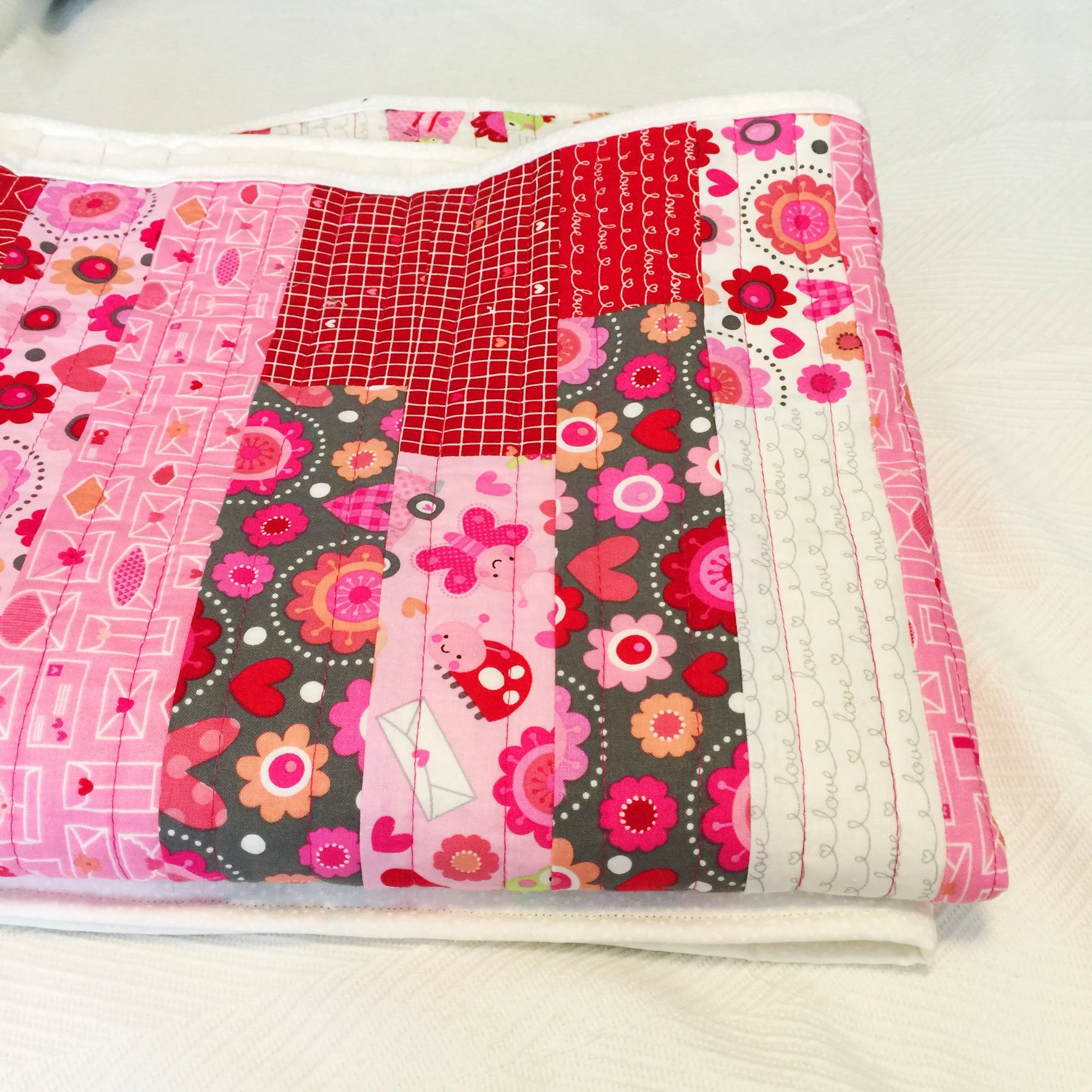 jelly roll baby quilt using Doodlebug for Riley Blake Lovebug collection fabric