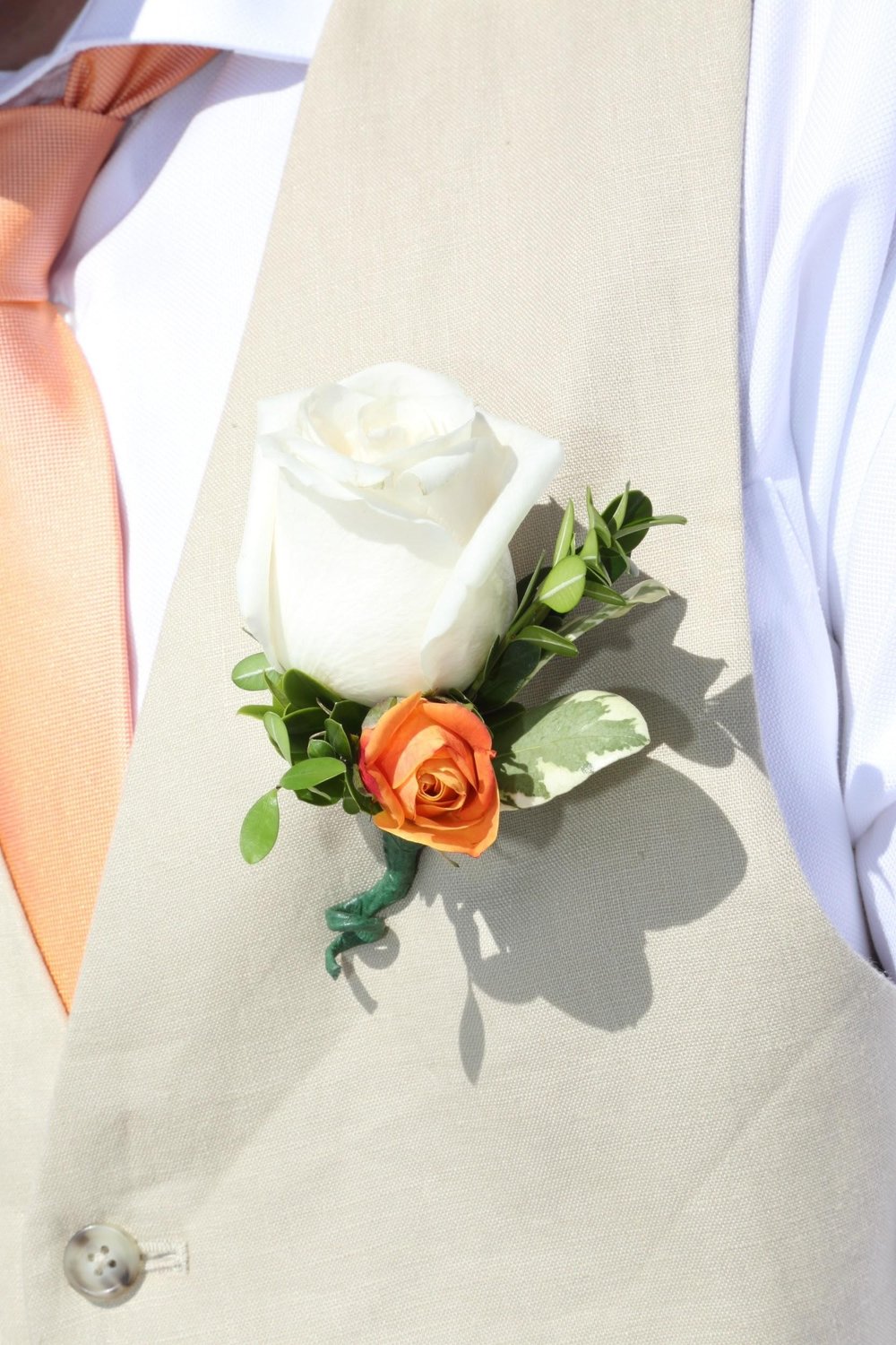 The groom had a touch of peach to match the bridal bouquet