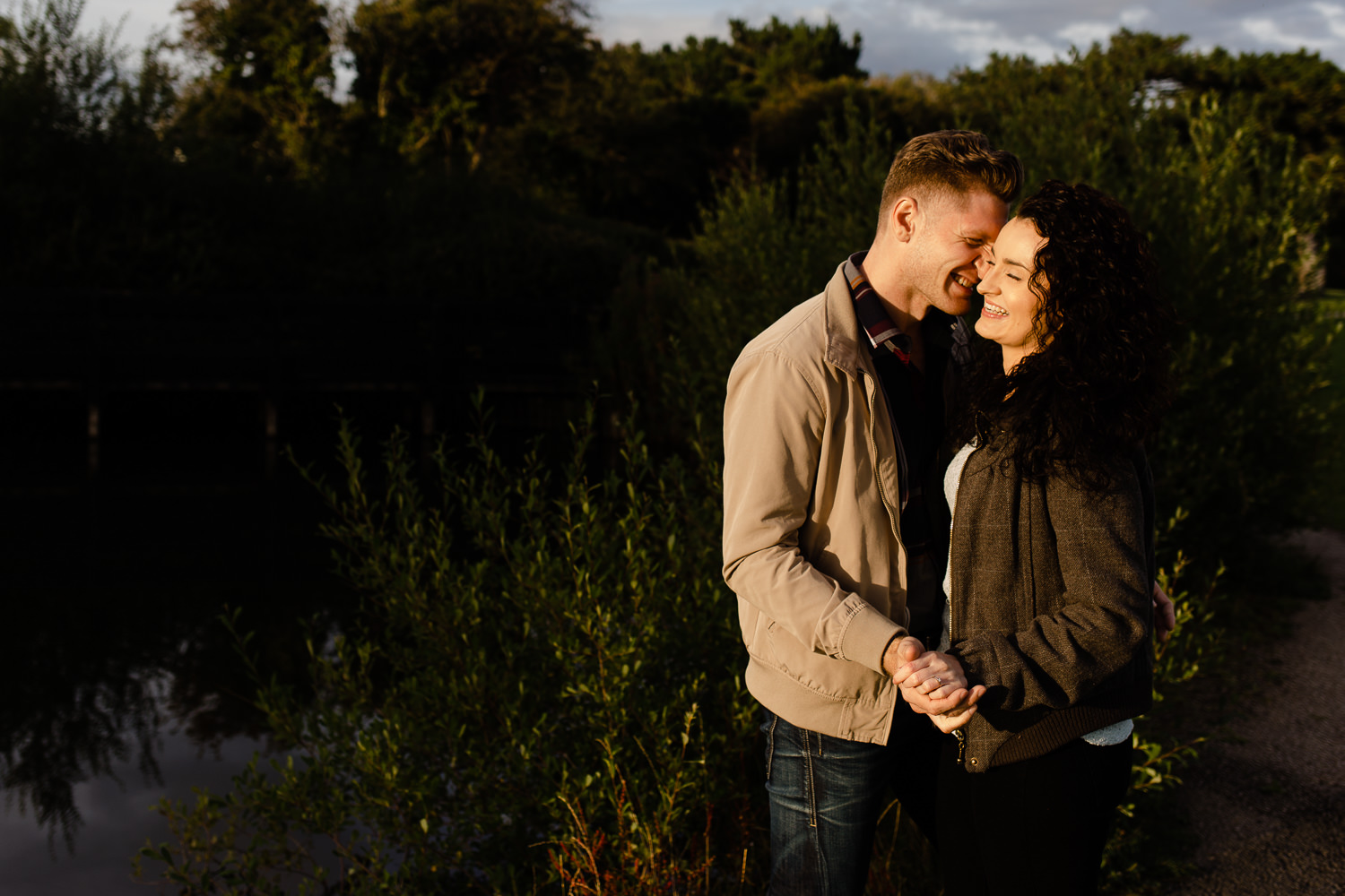 Couple leaning in close and laughing on their pre wedding shoot in Merseyside