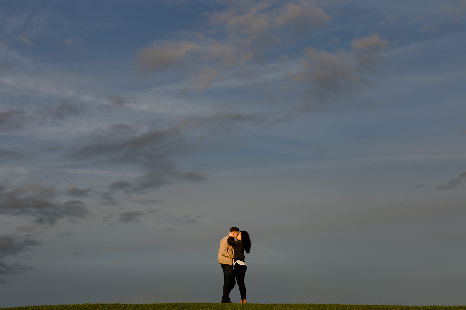 Golden Hour sky with a couple on a hill in Wirral Country Park - Merseyside wedding photography
