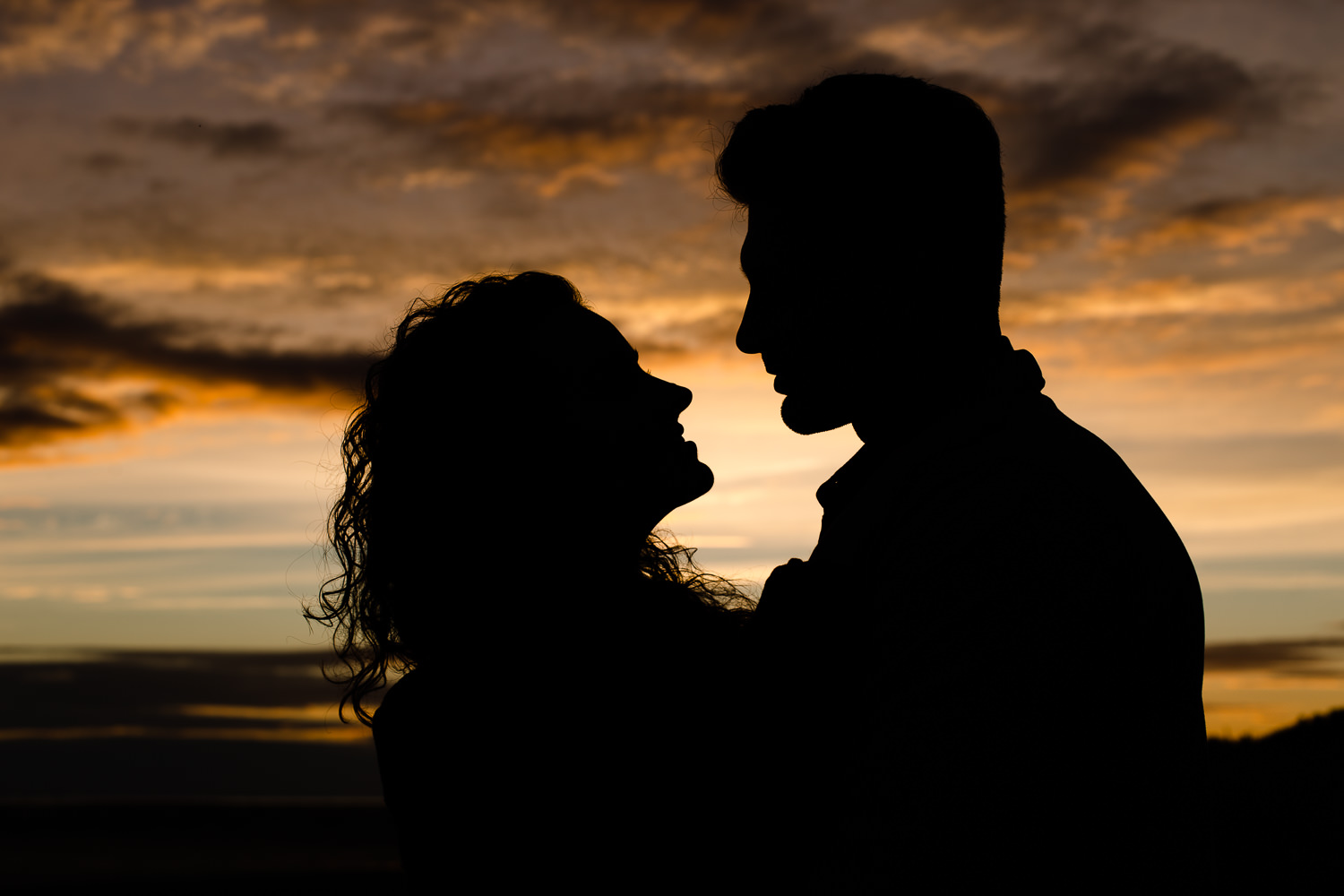 Couples silhouette against the colourful sunset sky - Wirral Country Park 