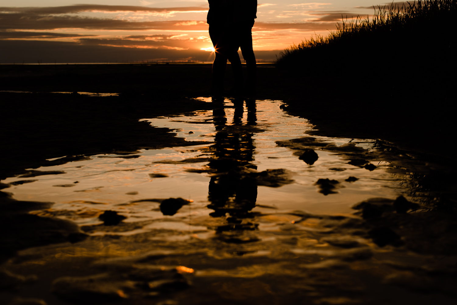 Silhouette and reflection of a couple on a wet beach - Wirral Country Park, Merseyside, Pre Wedding Shoot at Sunset