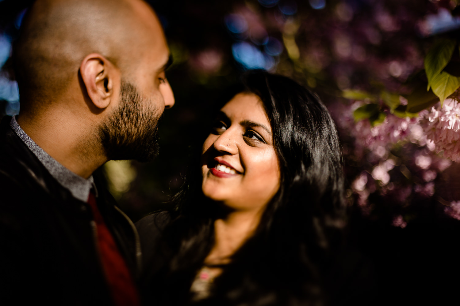 Freelensing image of a Hindu woman looking into her partners eyes on an engagement shoot.
