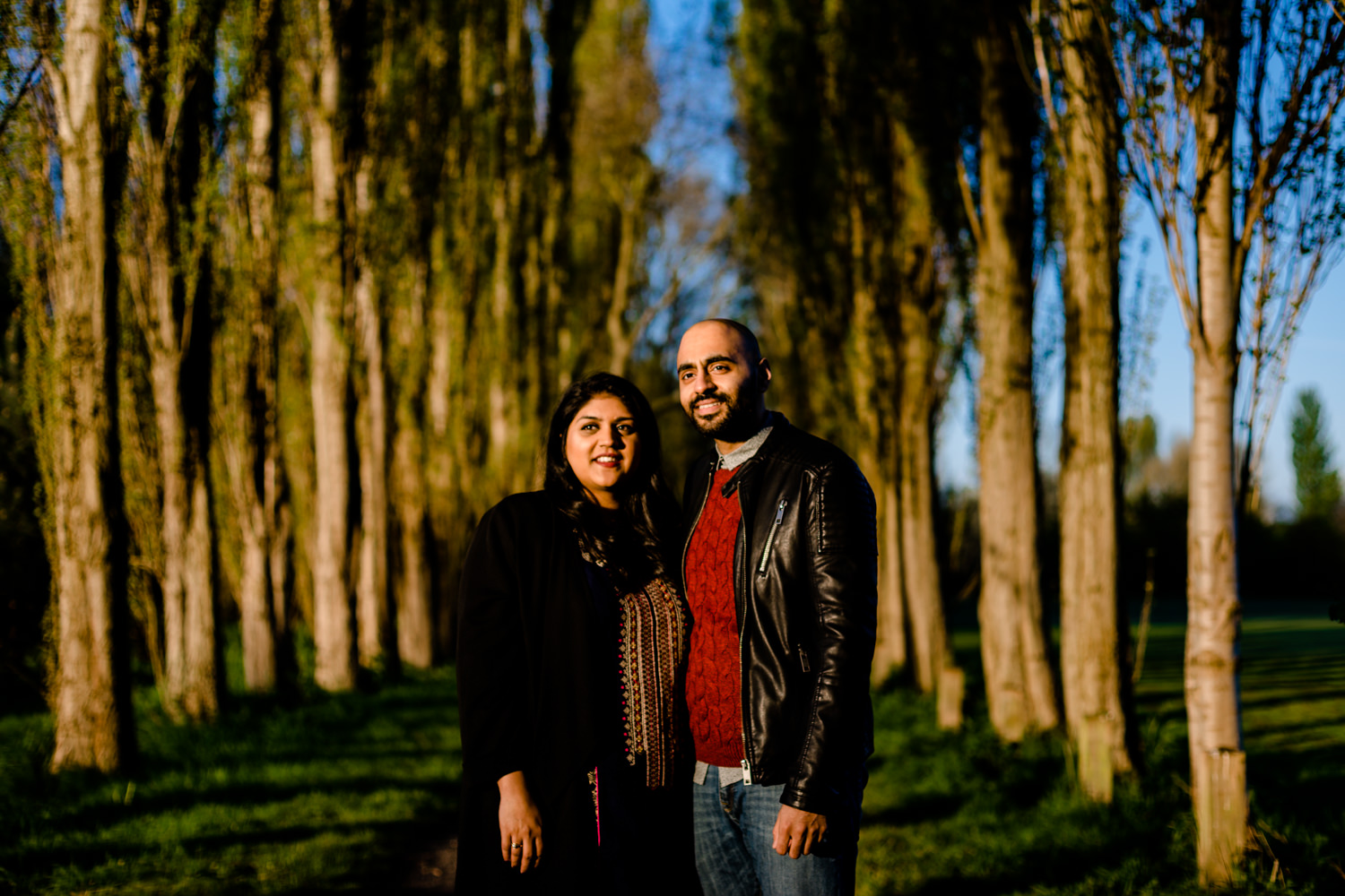 Hindu couple stood between trees at sunrise on a pre wedding shoot in Manchester
