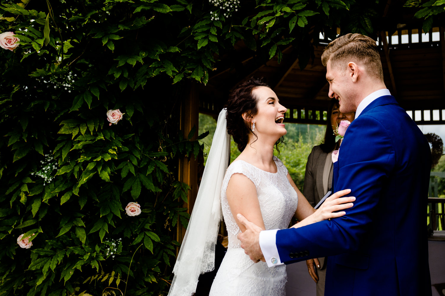 Outdoor garden ceremony , bride smiling at her groom, in Cheshire.