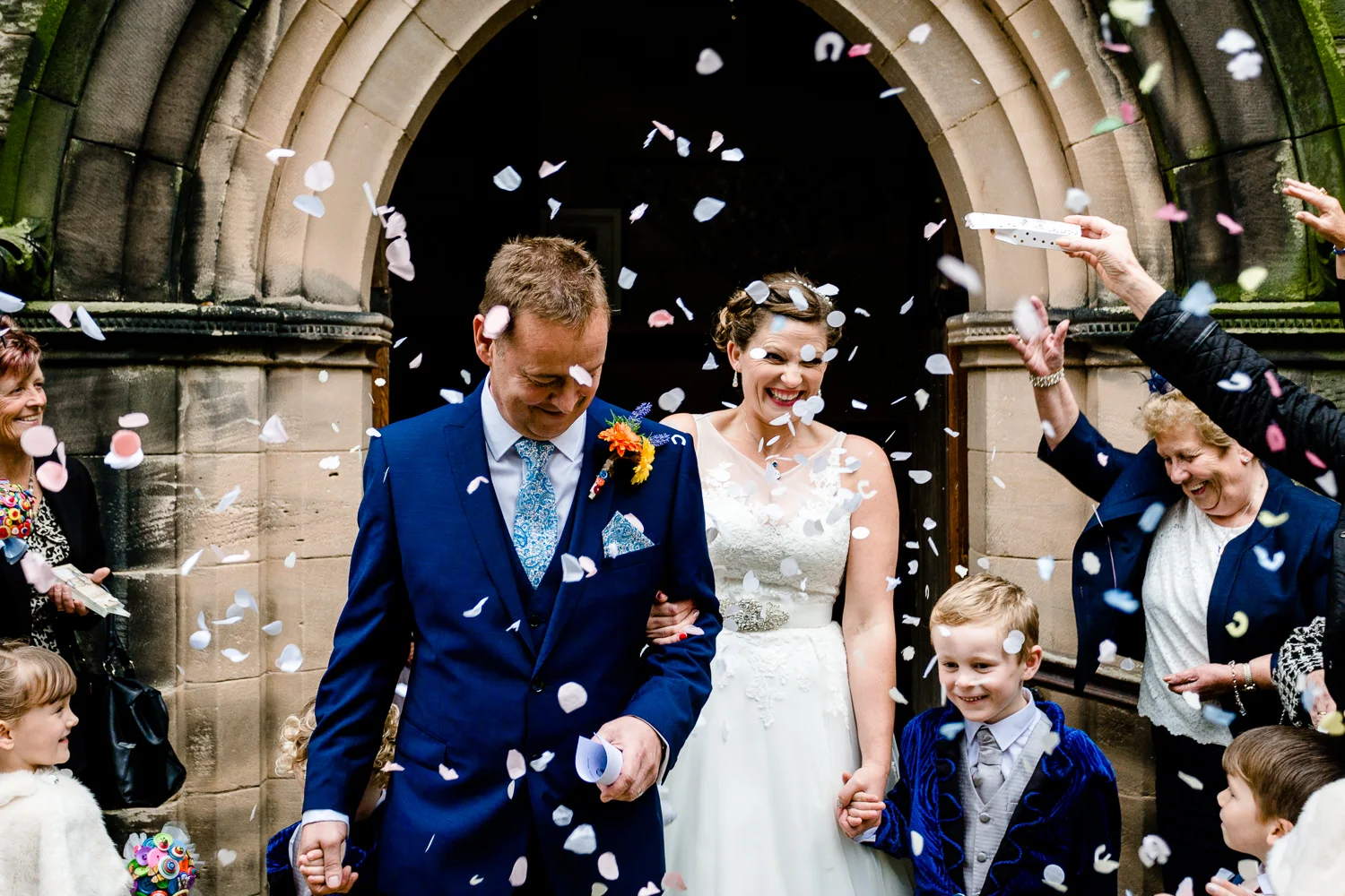 Confetti being thrown over a bride and groom outside a wedding at Christ Church in Bebington, Wirral.