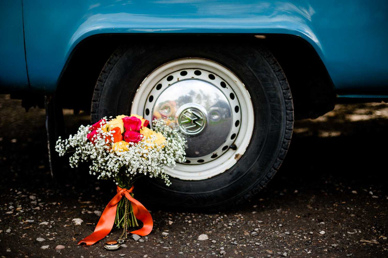 A colourful bouquet and blue VW camper van at a wedding in Wirral at Thornton Manor. 