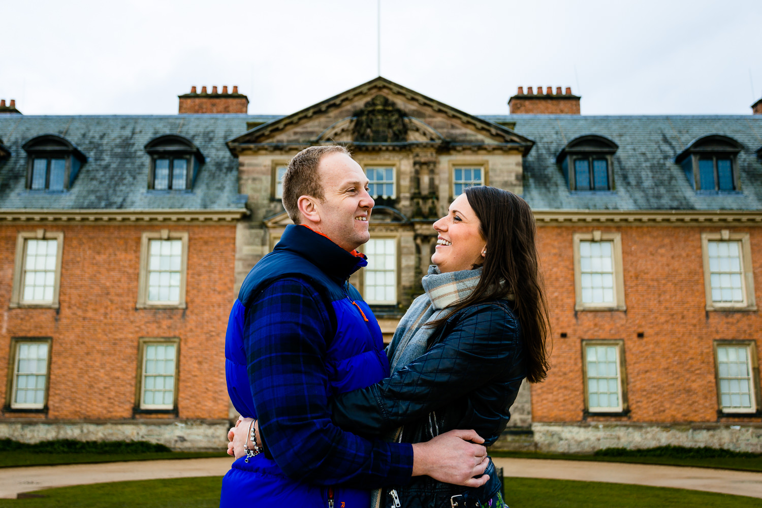 Claire and Damien laughing together in their Dunham Massey pre wedding shoot.
