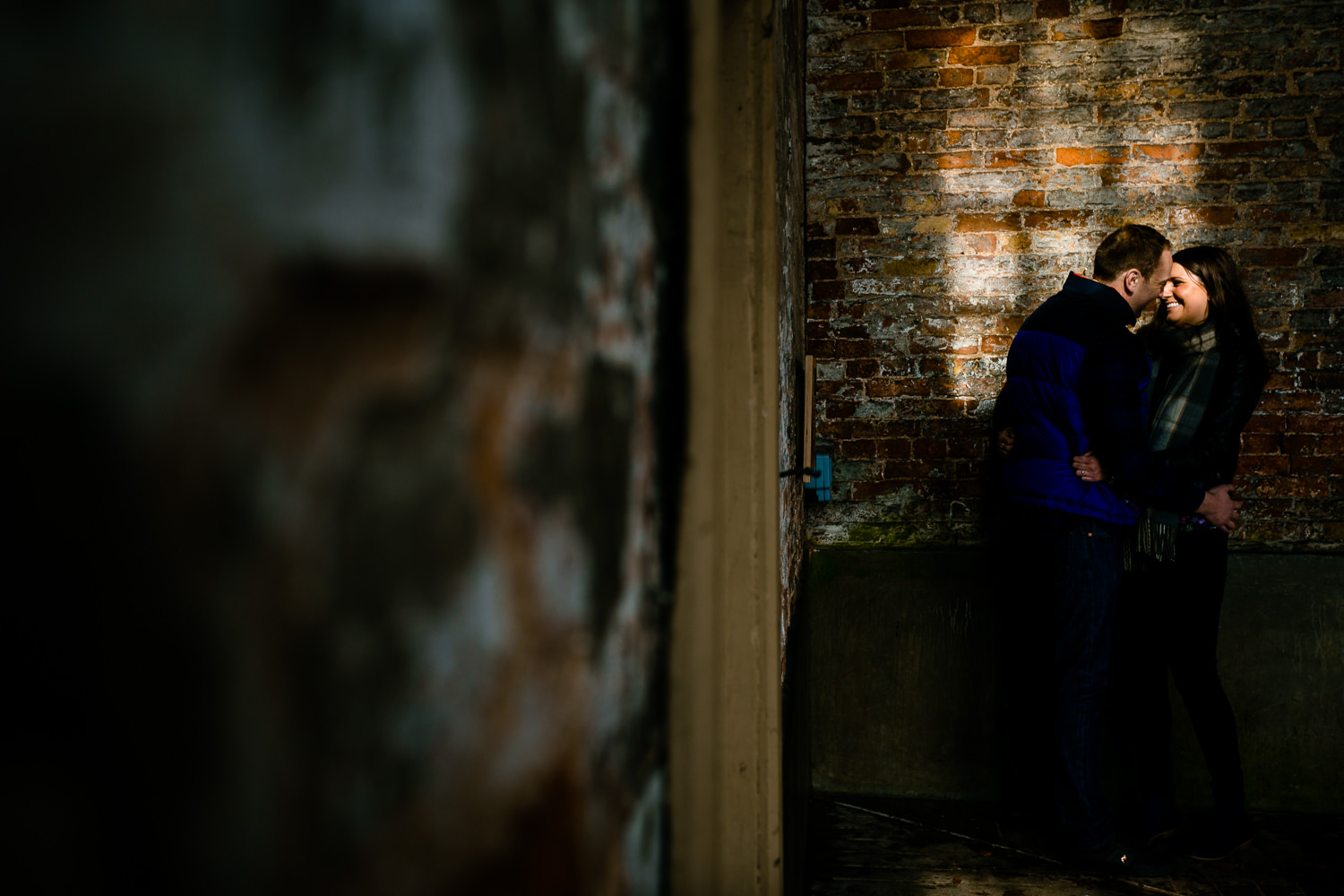 Window light on a cuddling couple on their Dunham Massey pre wedding shoot.