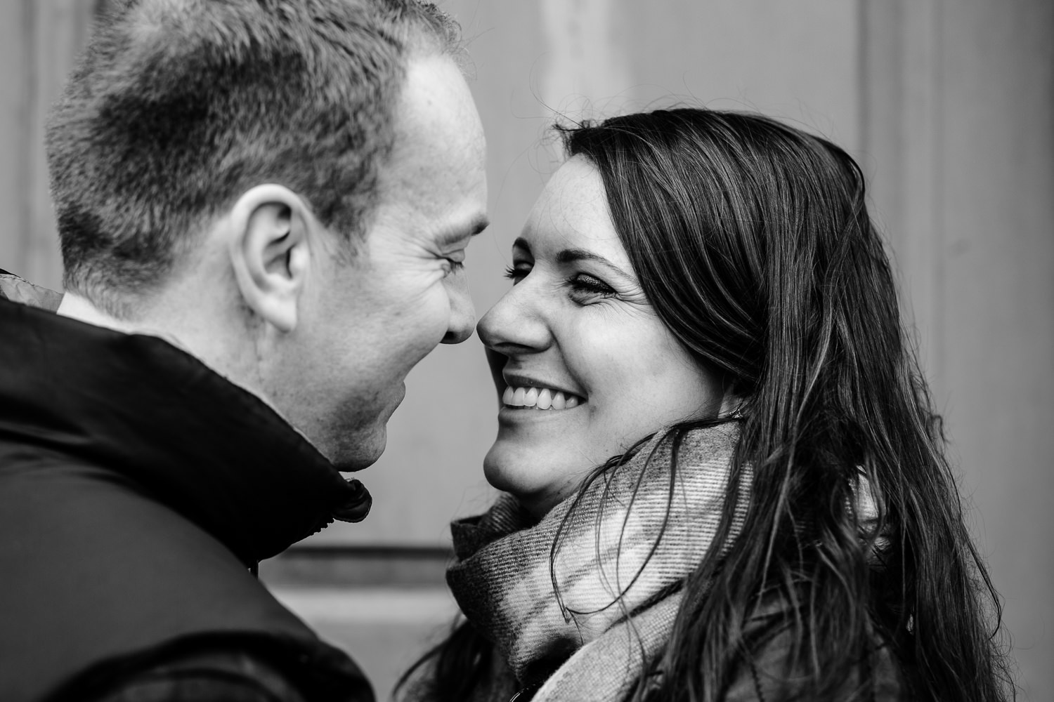 Close up of a giggling couple on a pre wedding shoot. 