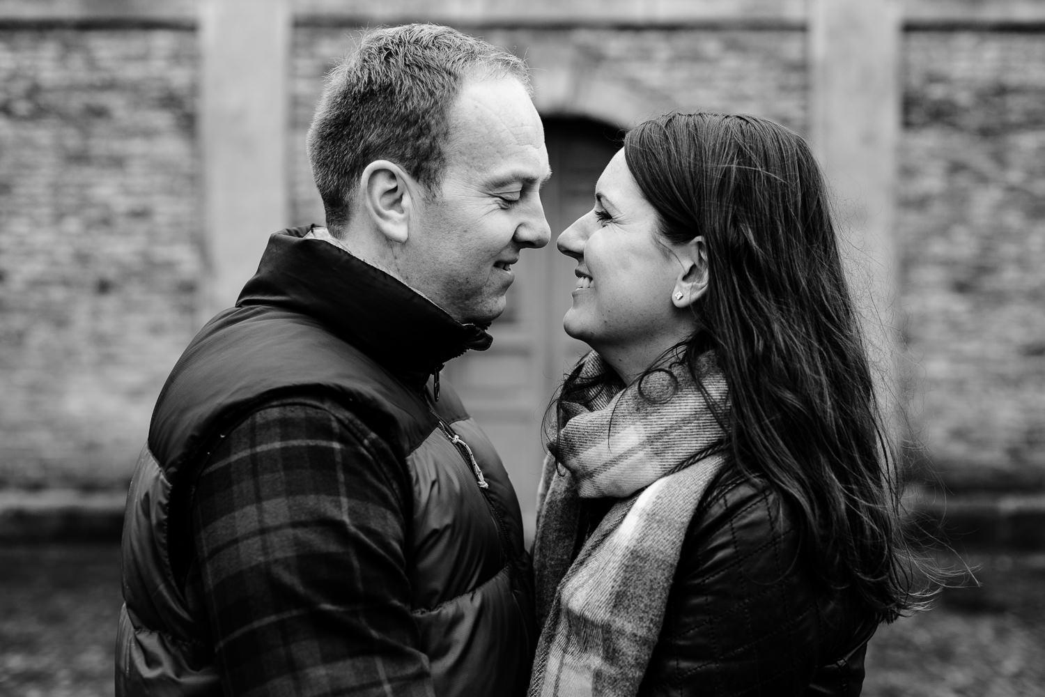 Black and white photo of a couple facing each other on their pre wedding shoot at Dunham Massey park. 