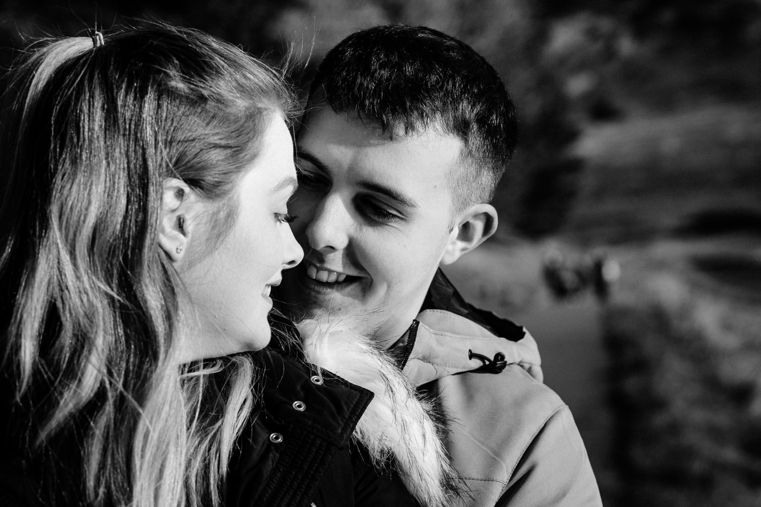 A black and white close up of a couple smiling on their pre wedding shoot.