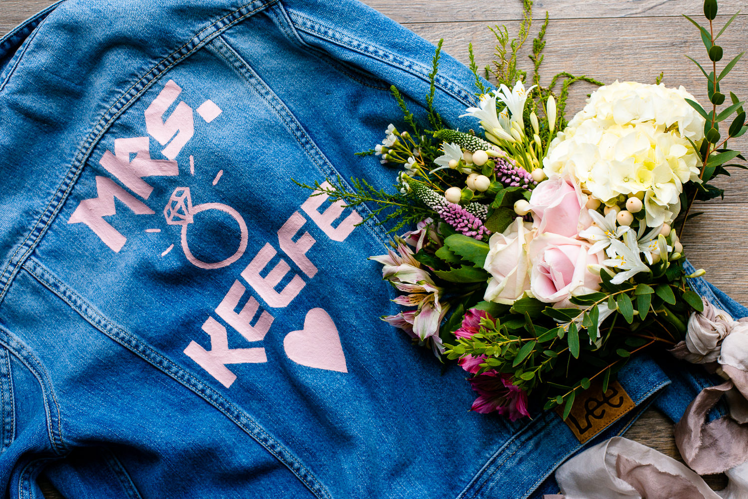 Festival Boho wedding styling, wild flower bouquet and cool printed denim jacket for a tipi wedding in Anglesey. 