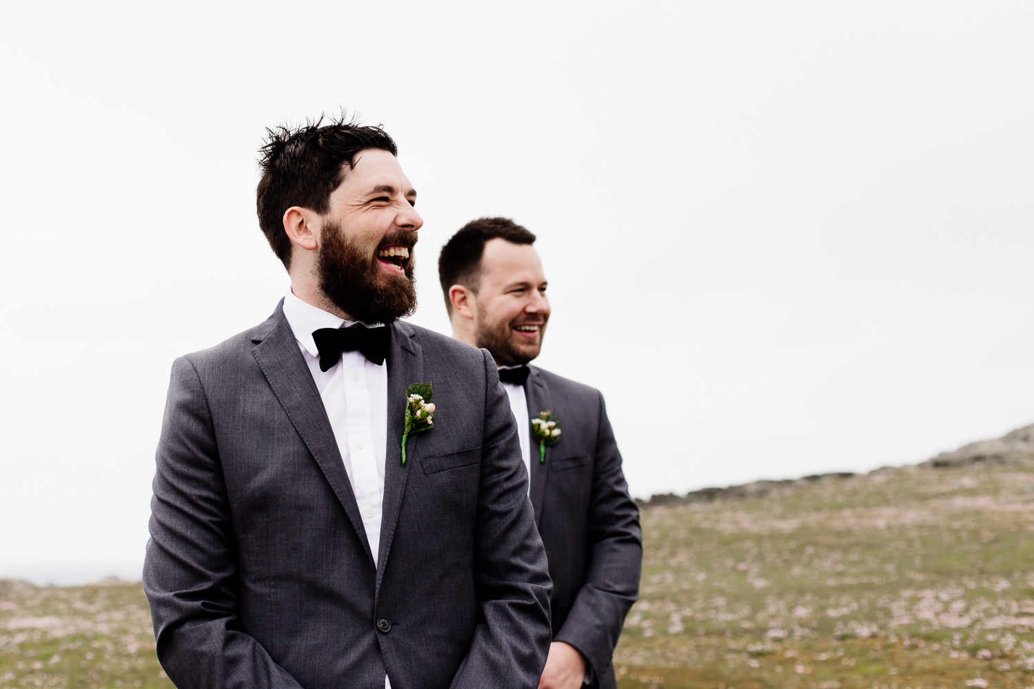 Groom laughing at his wedding in Anglesey, Wales.