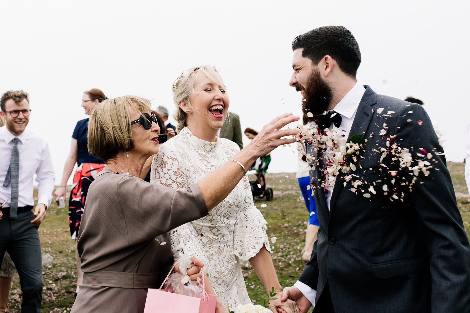 Confetti being thrown at a groom, by Wales wedding photographers, About Today Photography.