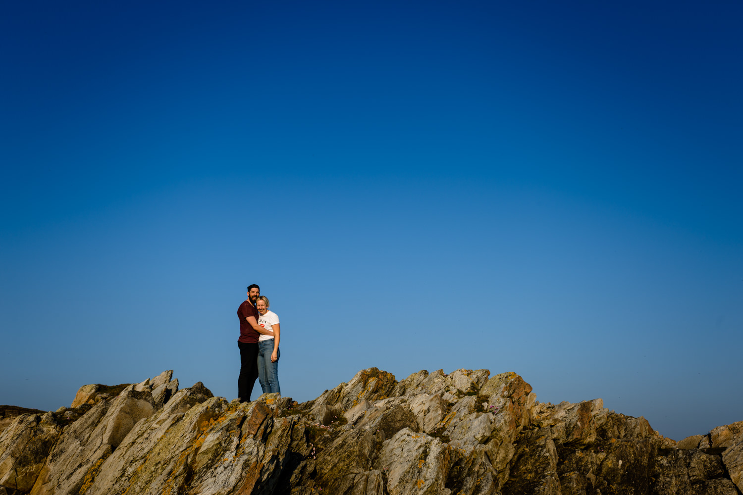 Pre wedding shoot on the rocky cliffs of the Rhoscolyn headland, by wedding photographers About Today Photography. 