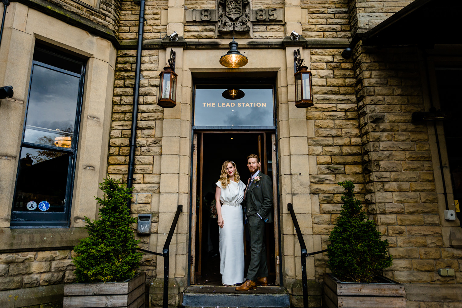 The Lead Station, a wedding venue in Chorlton Manchester, Rose &amp; Josh standing in the doorway.