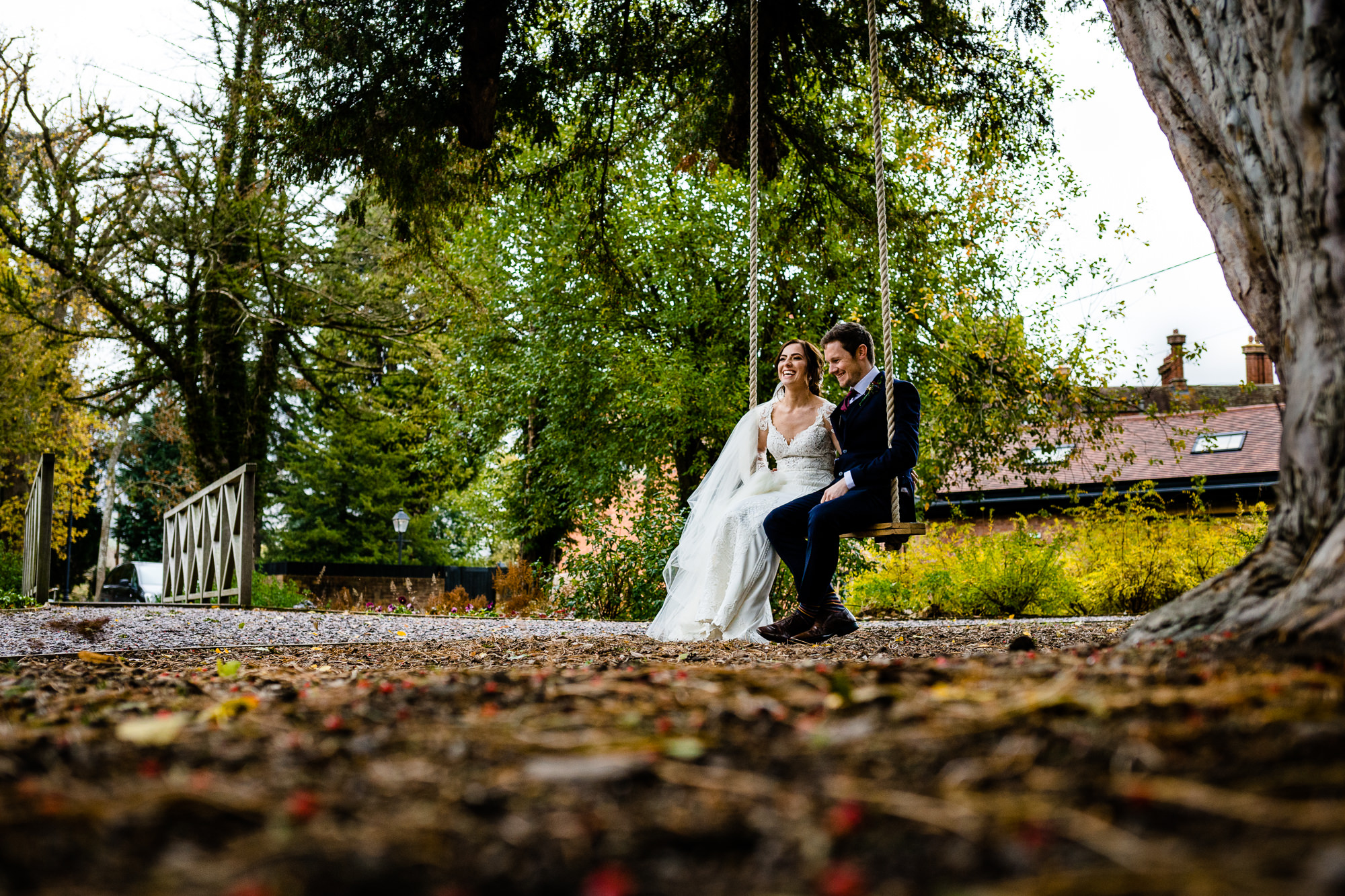 Nicola and Dave sat on the swing at Tyn Dwr Hall on their wedding day
