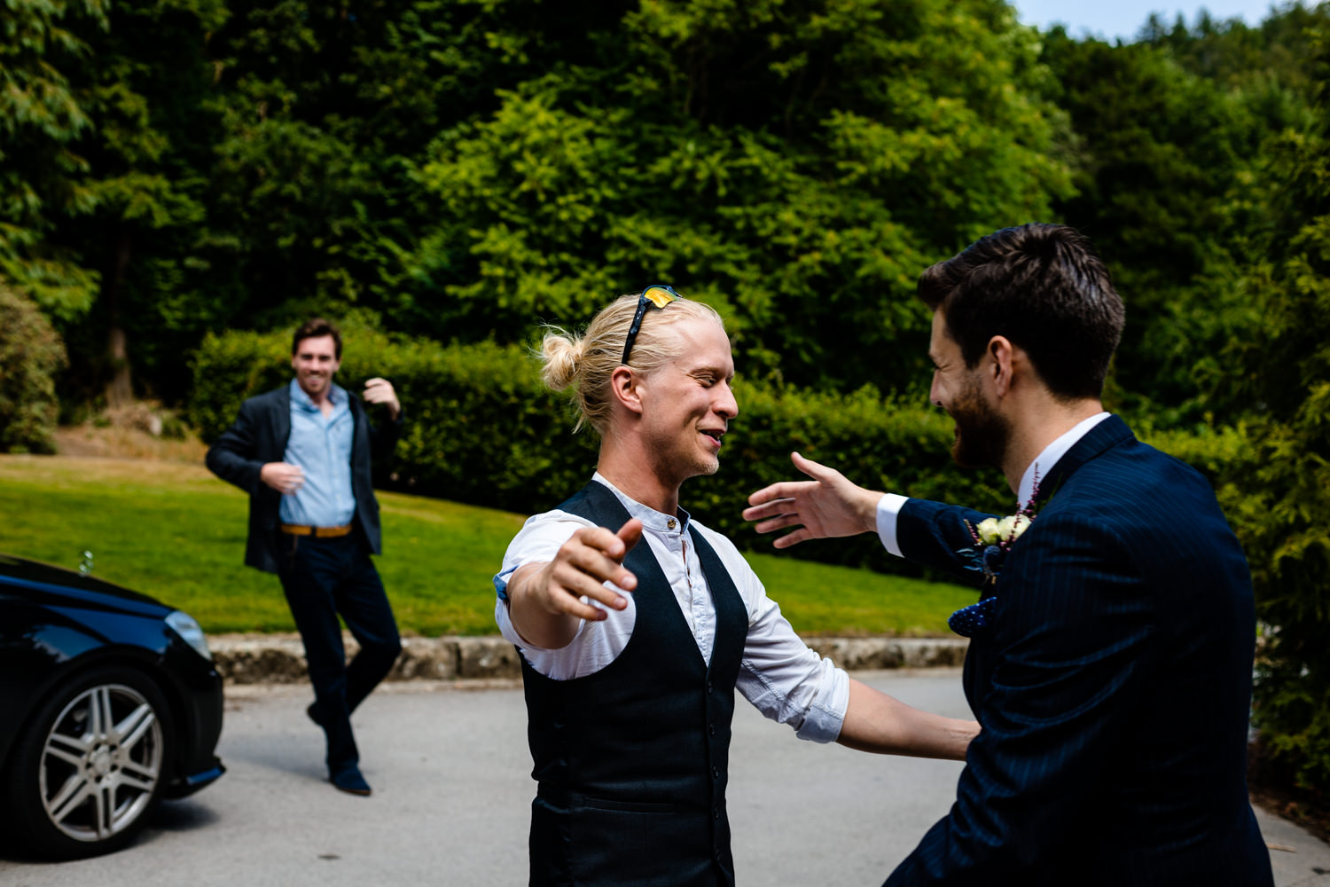 Guests greet the groom outside Whirlowbrook Hall.