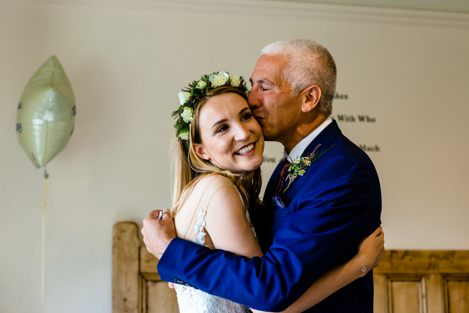 A father and daughter hug, wedding photographer Whirlowbrook Hall