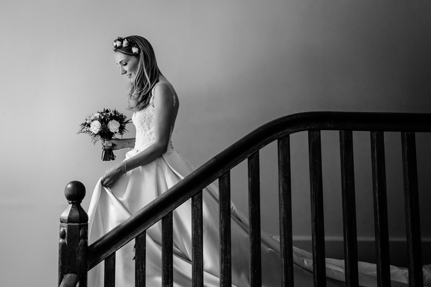 Whirlowbrook Hall wedding photographer, a Mori Lee bride coming down the stairs