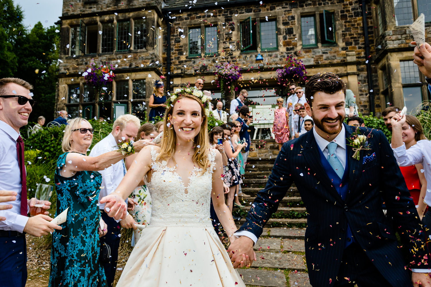 Confetti being thrown at a bride and groom, Whirlowbrook Hall wedding photo.