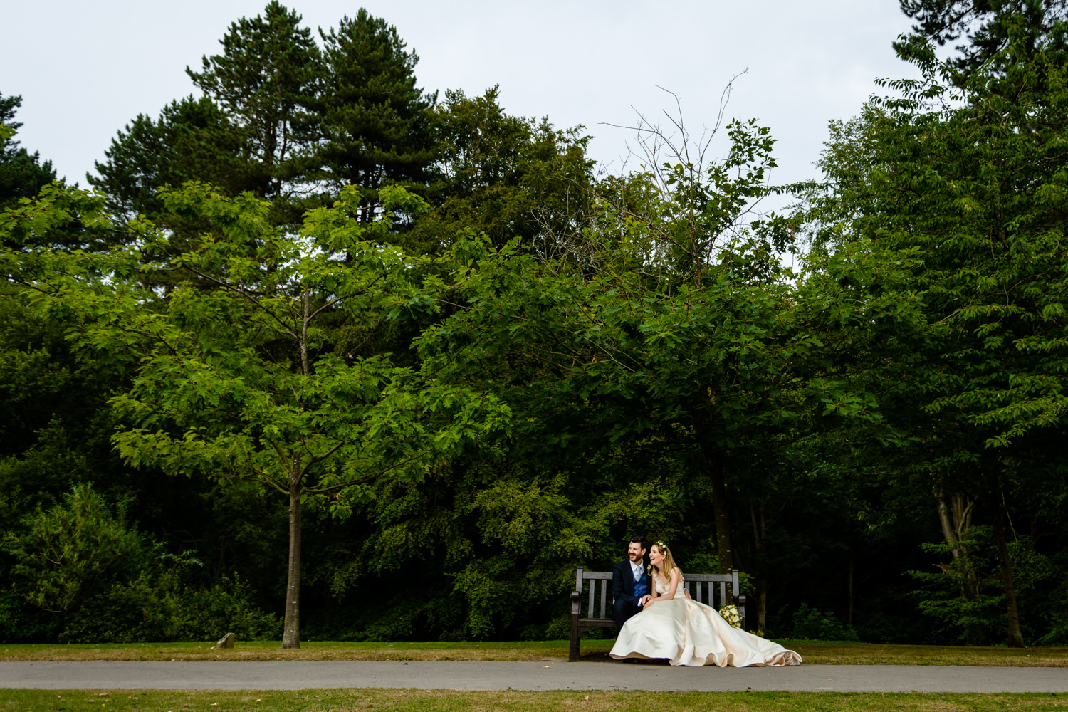Bride and groom relaxing on a bench, wedding	photos	Whirlowbrook Hall 