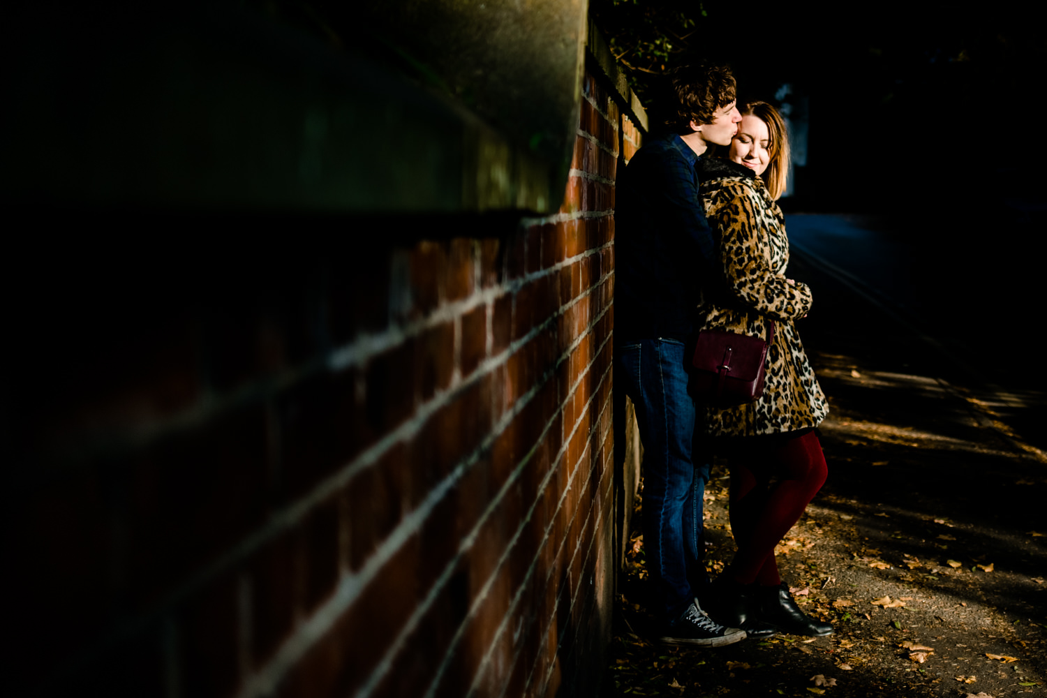 Didsbury Wedding Photographers, a couple cuddle in the sun set light at Fletcher Moss Park
