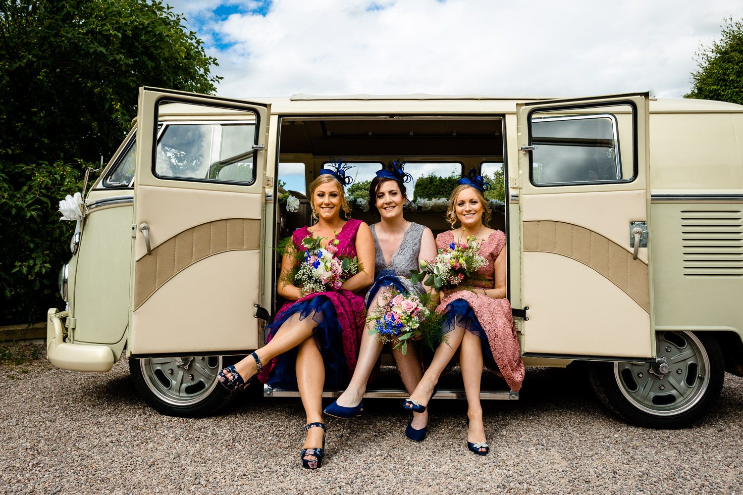 Colourful and retro bridesmaids in a vintage wedding VW campervan